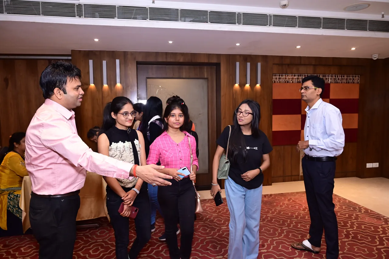 Participants talking together beside an education event desk